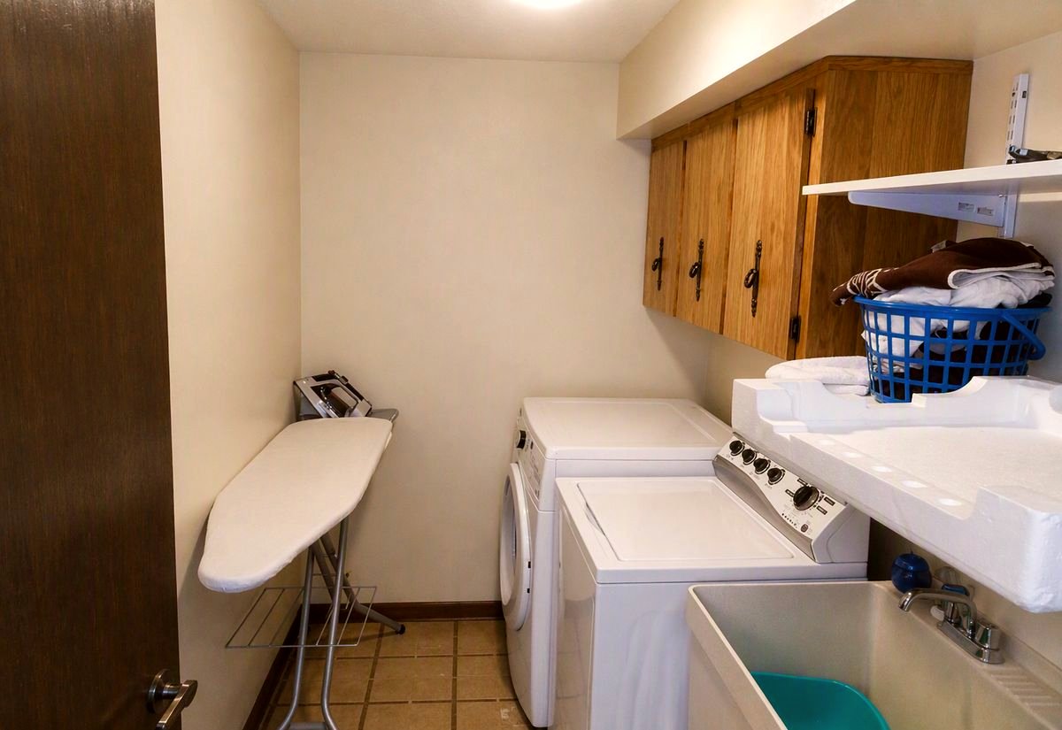 Dated laundry room before renovation