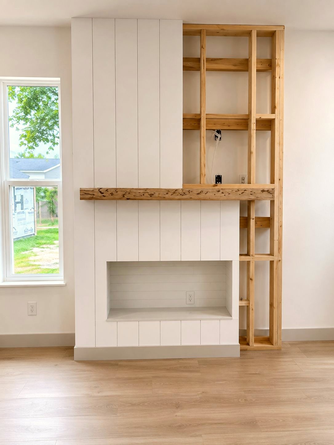 Custom shiplap fireplace built-in under construction